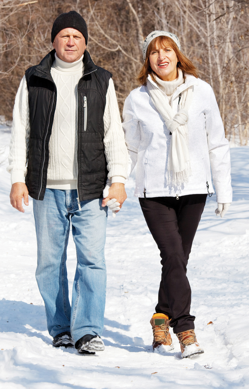 Happy seniors couple in winter park