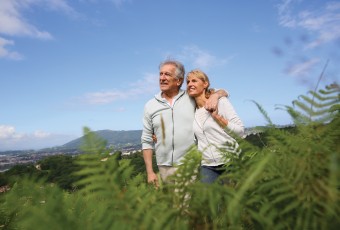 Senior couple walking in countryside, scenery