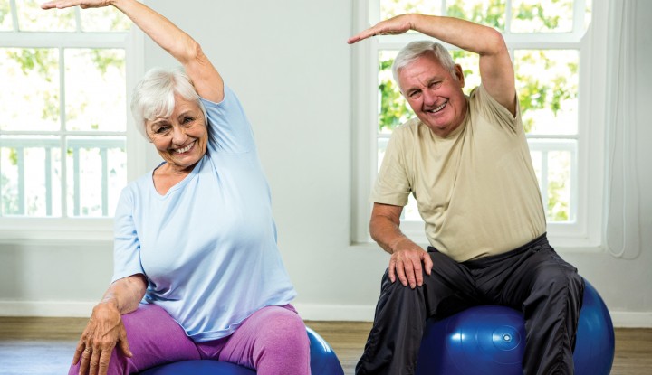 Senior Couple Stretching on Exercise Balls