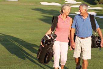 Senior Couple Walking on Golf Course